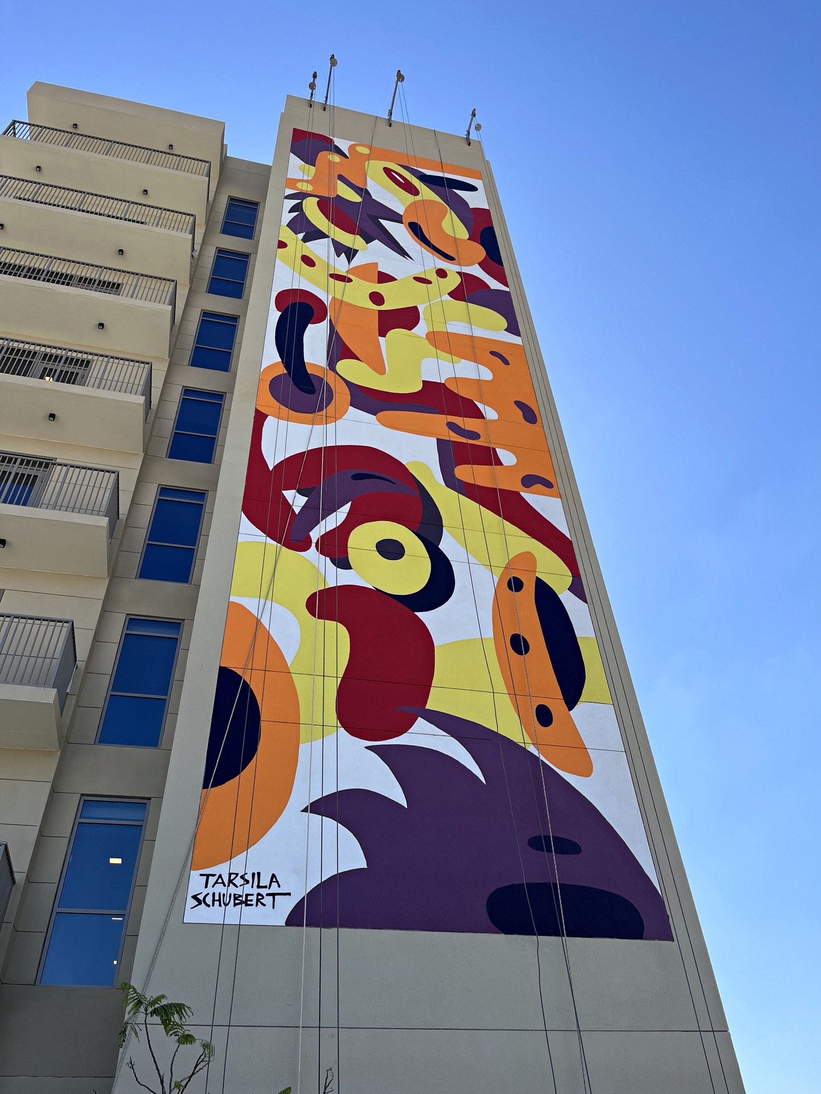 Tarsila Schubert’s completed organic red, orange and yellow mural in its architectural setting