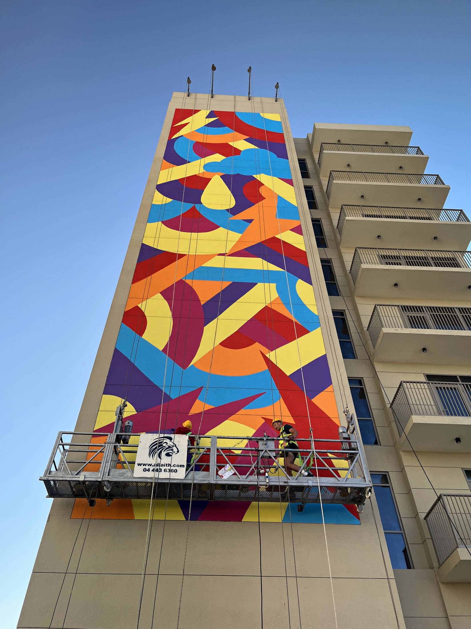 George Rollo’s completed geometric mural with the specialist crew working from a suspended cradle