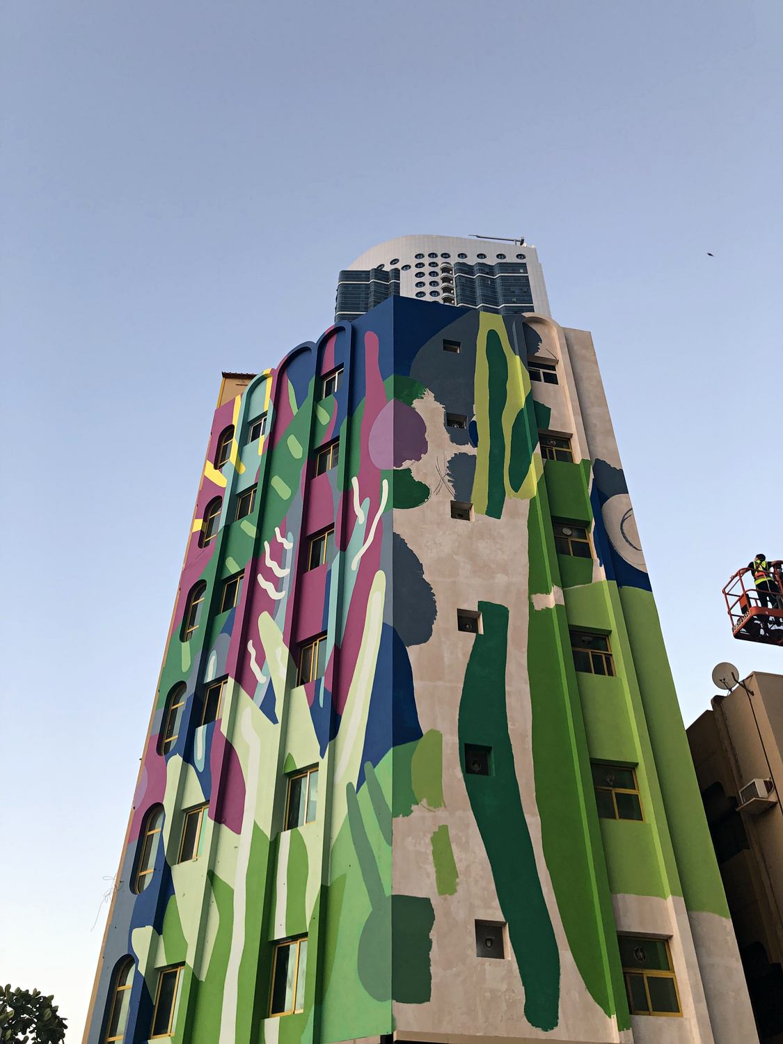 Final mural details being completed from a boom lift