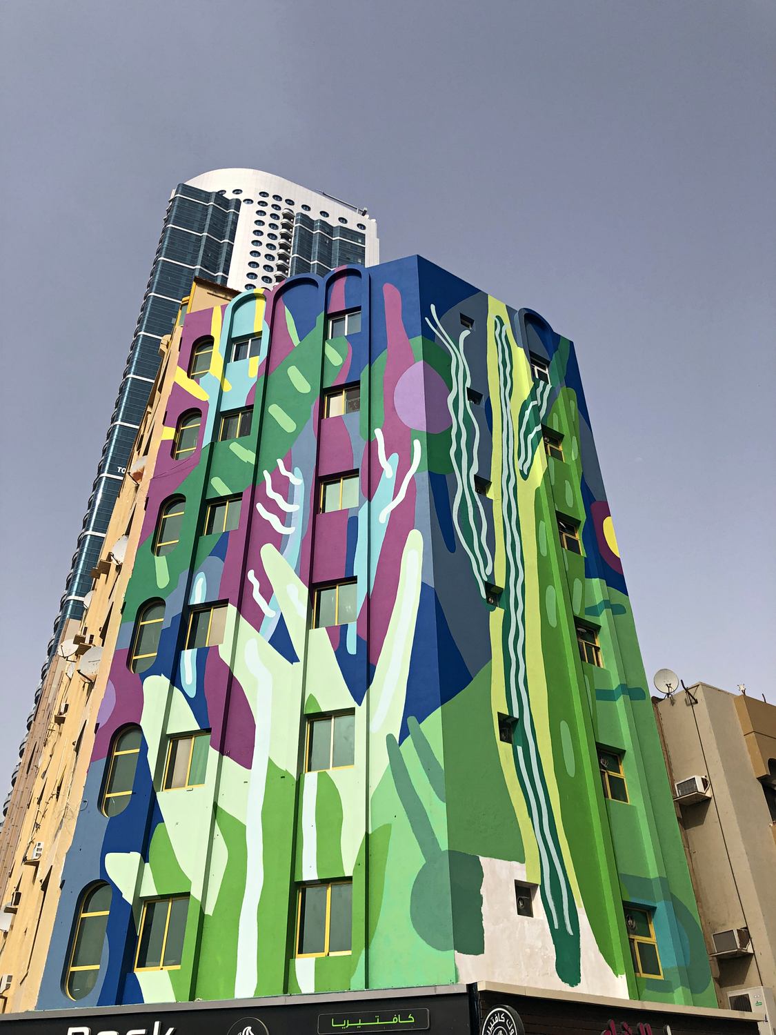 Completed multi-storey mural covering an architectural facade in Ajman