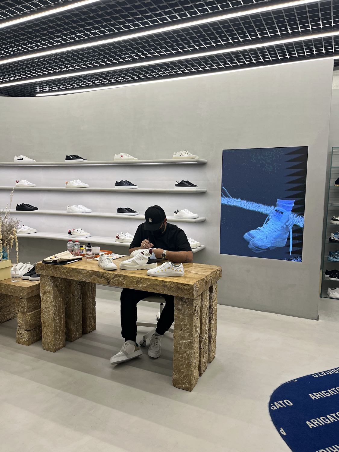 Artist customising footwear live inside Axel Arigato