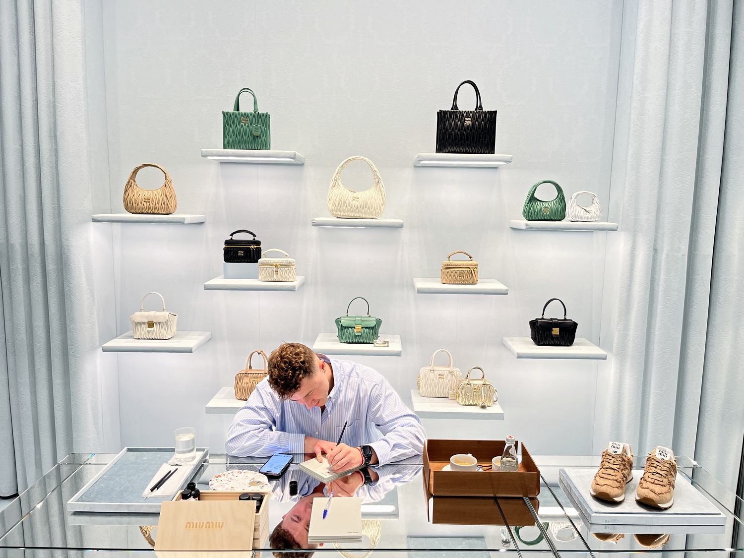 Prepared artist station inside the Miu Miu store