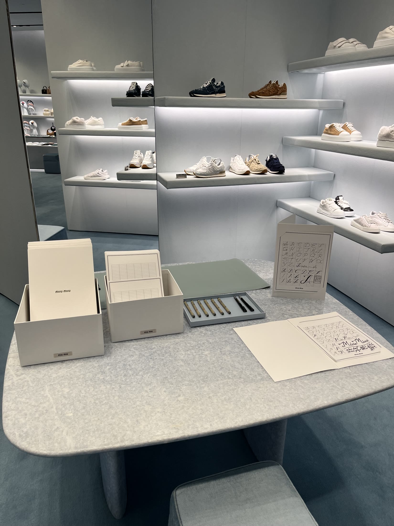 Complete Miu Miu calligraphy station with materials and prepared examples