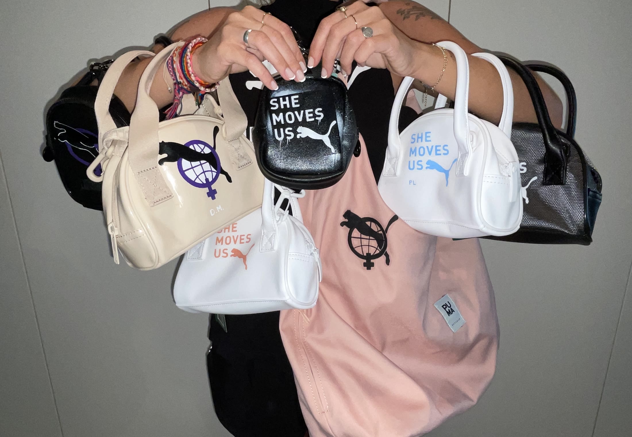 A collection of customised Puma She Moves Us bags