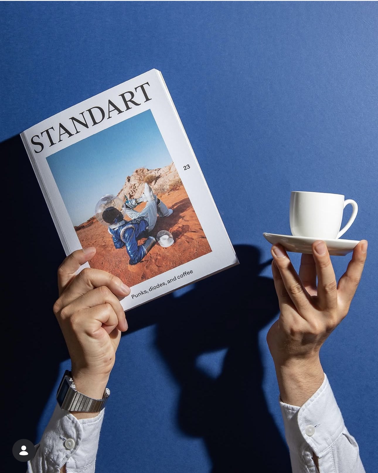 Standart Magazine issue 23 held beside a coffee cup
