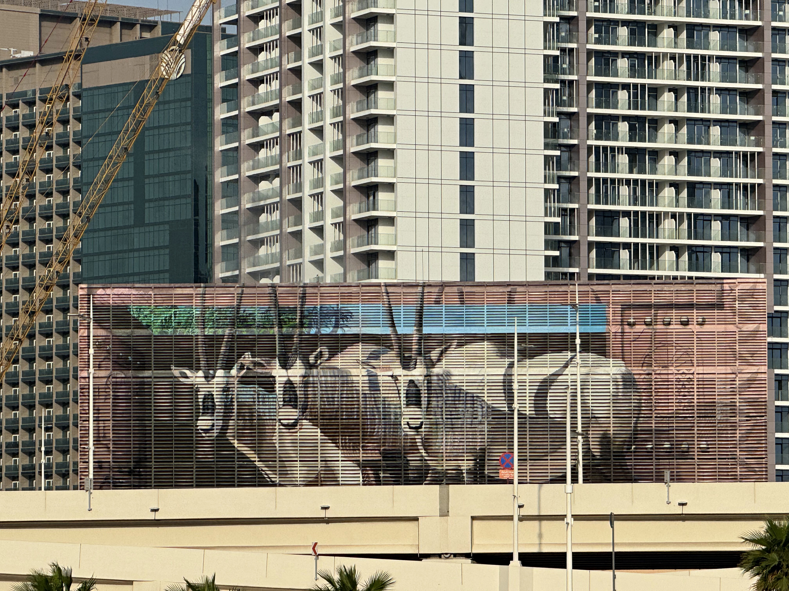 The completed animal mural across the Tabreed Al Maryah louvre facade