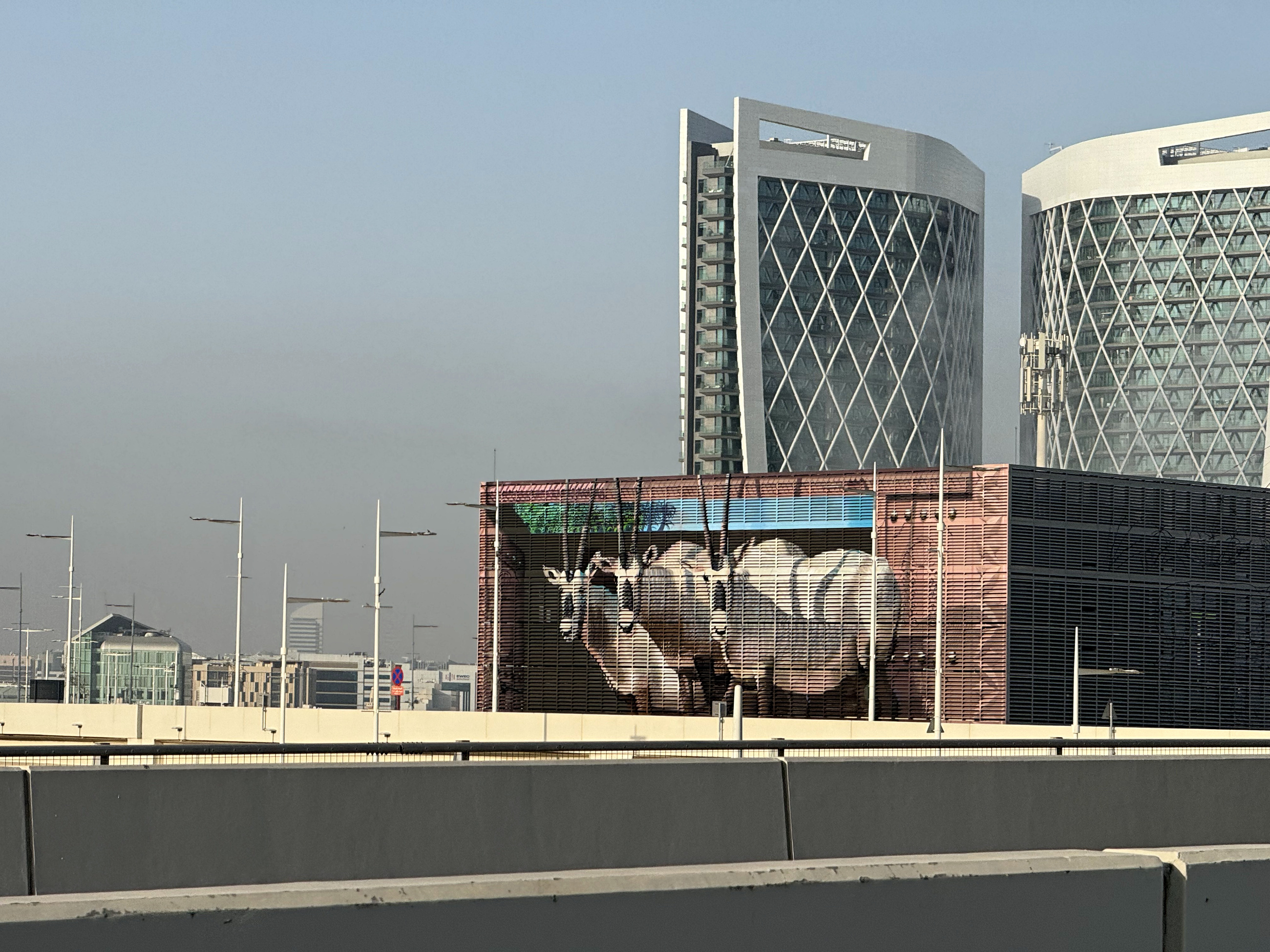 The completed Tabreed mural seen within the Al Maryah urban context