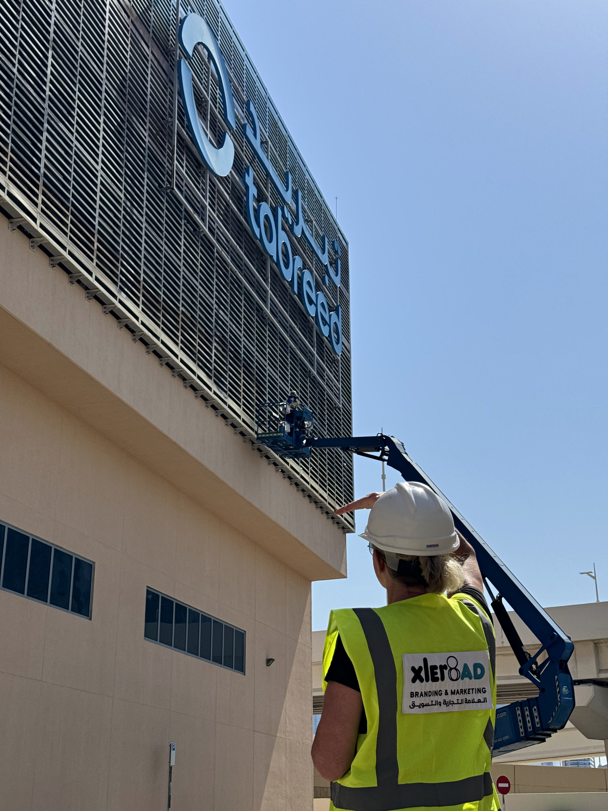 XLer8 AD overseeing elevated work beside the Tabreed identity