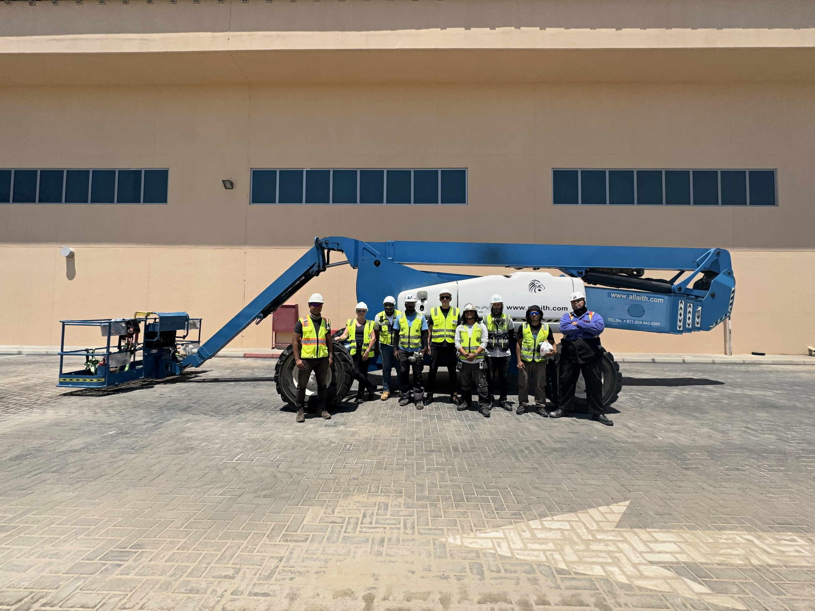 The Tabreed Al Maryah project delivery team in front of a high-access boom lift