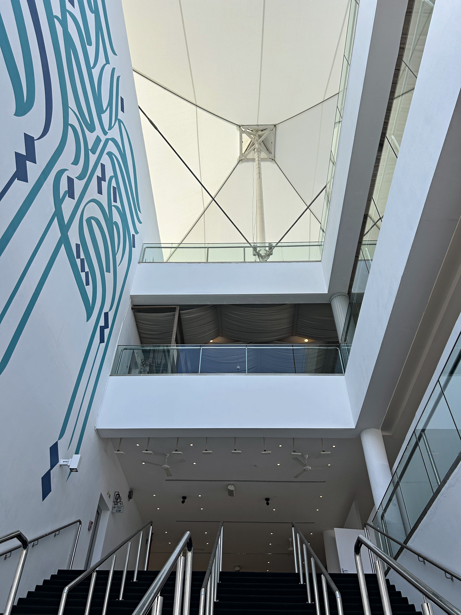 The completed monumental mural rising through the Paddock Club staircase
