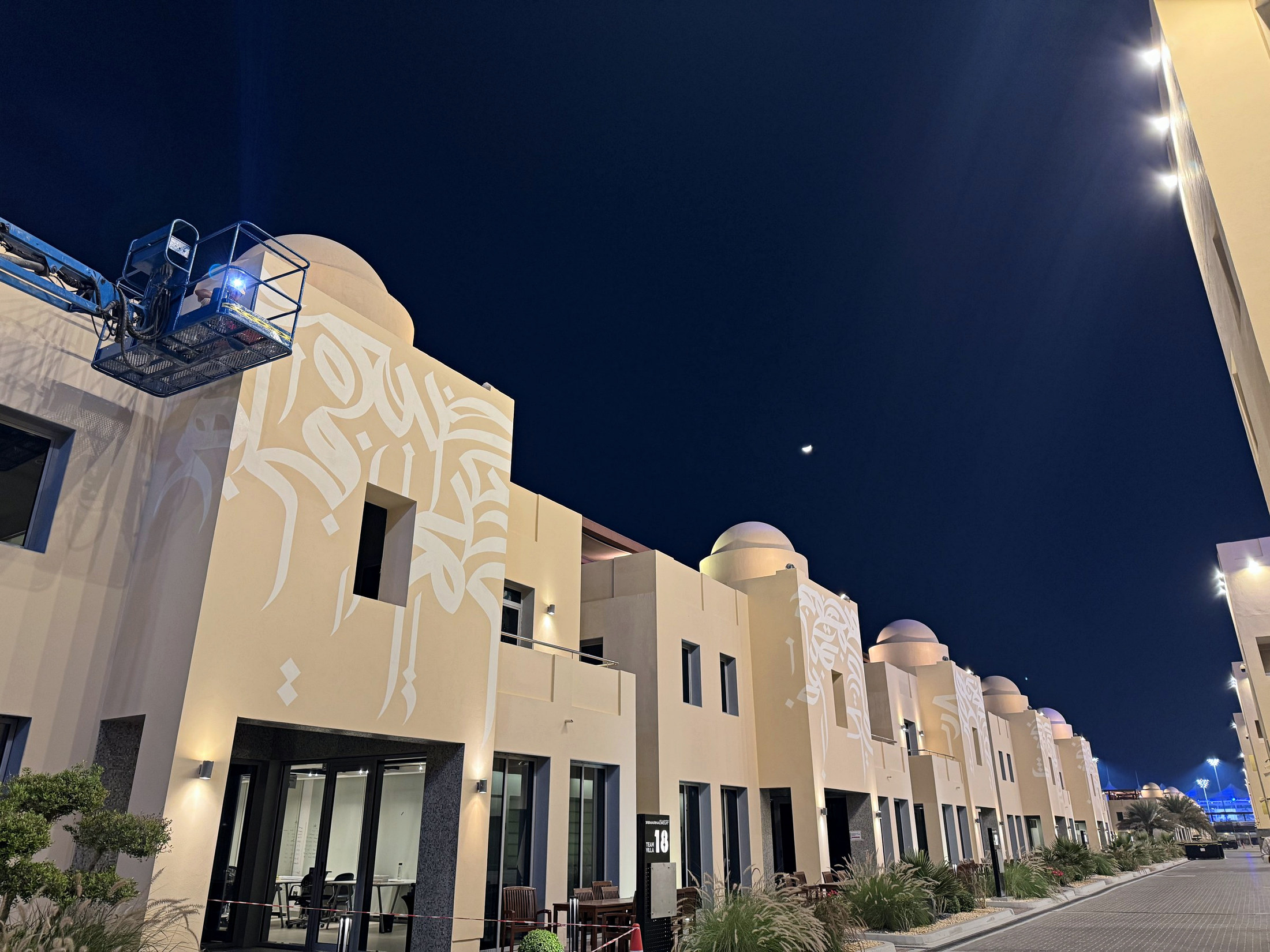 A completed row of hand-painted Team Villas at night