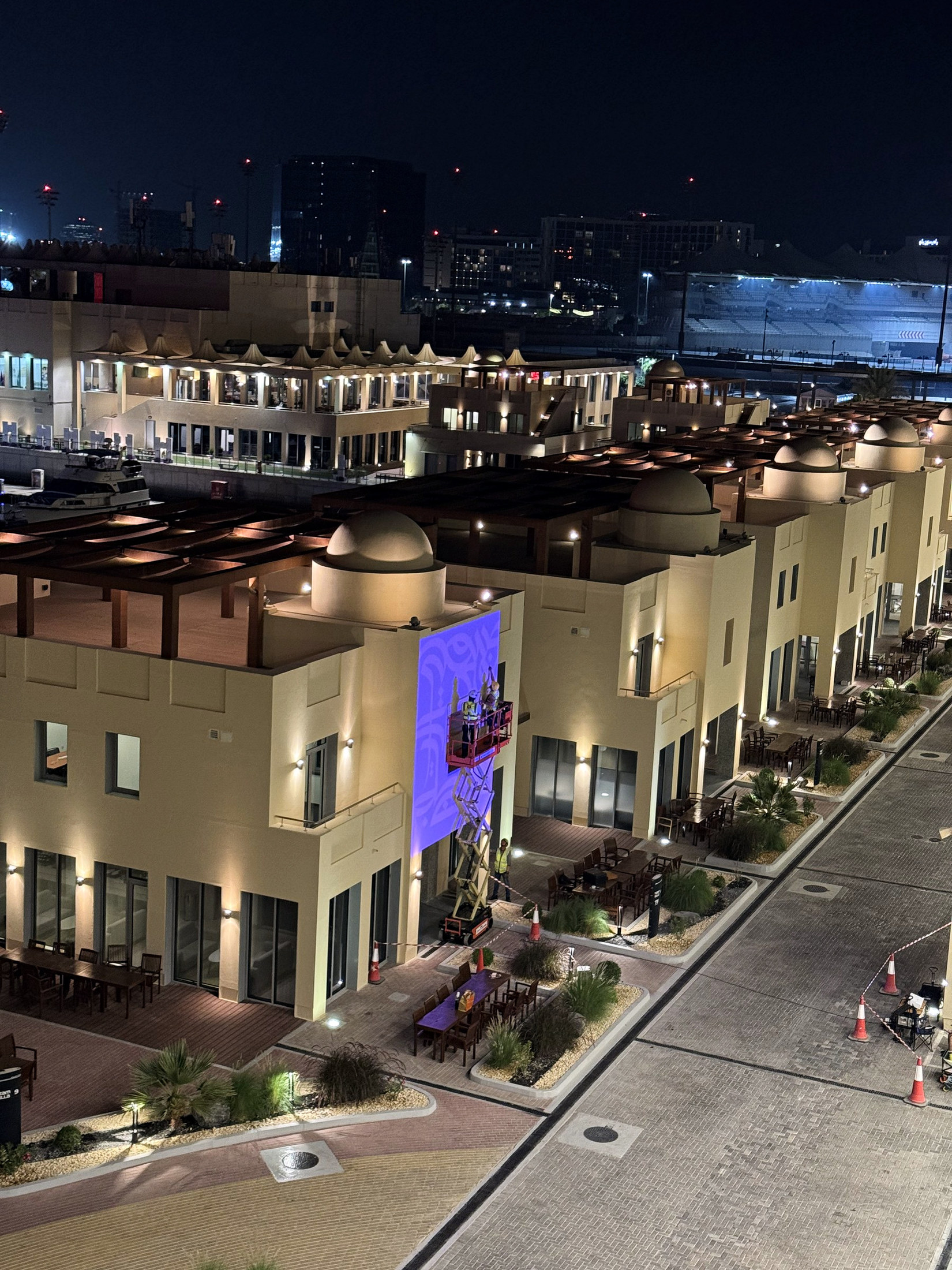 Elevated view of the Team Villas with lift equipment operating below