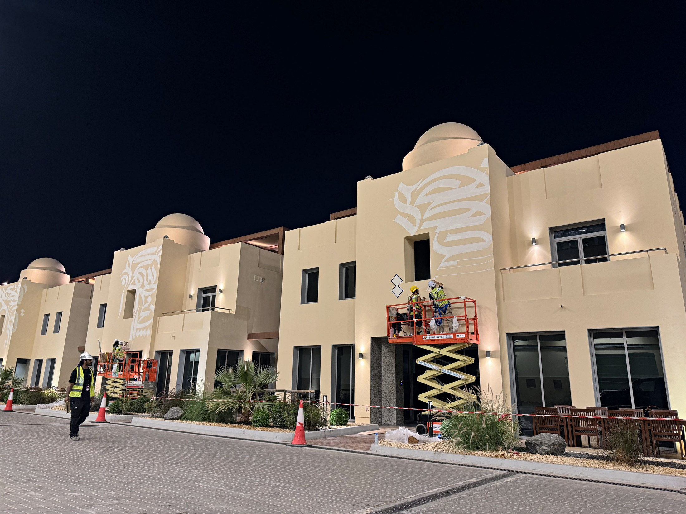 Multiple scissor lifts positioned along the Team Villas